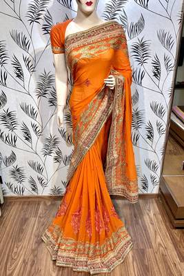 Pure georgette party wear saree in orange with embroidery work & crystal stone work 1