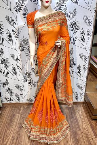 Pure georgette party wear saree in orange with embroidery work & crystal stone work