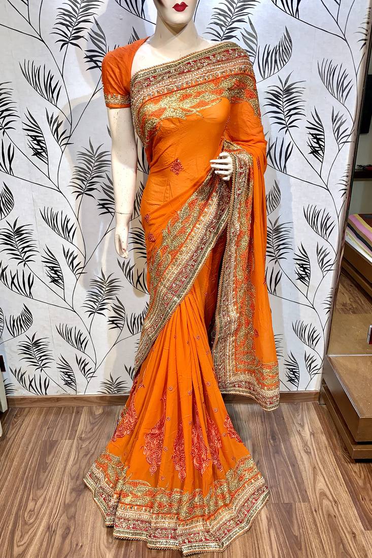 Pure georgette party wear saree in orange with embroidery work & crystal stone work