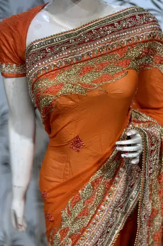 Pure georgette party wear saree in orange with embroidery work & crystal stone work