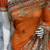 Pure georgette party wear saree in orange with embroidery work & crystal stone work