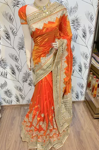 Pure silk party wear saree in orange with embroidery work & crystal stone work