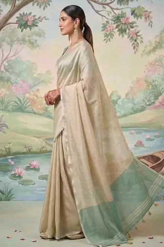 Beige color solid tissue silk blend plain saree with blouse