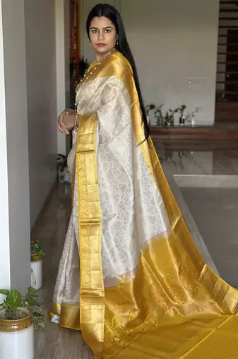  cream jacquard silk blend light weight saree with unstitched blouse