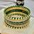 Gold plated set of 11 cz green silk thread bangle set