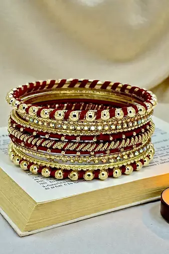 Gold plated set of 11 cz maroon silk thread bangle set
