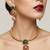 Handcrafted gold-plated ethnic necklace set with green carved stones & red floral pendant - bridal wedding jewelry