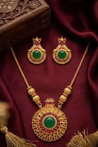 Handcrafted ethnic gold-plated necklace set with green emerald-style stones & ruby accents - traditional bridal jewelry
