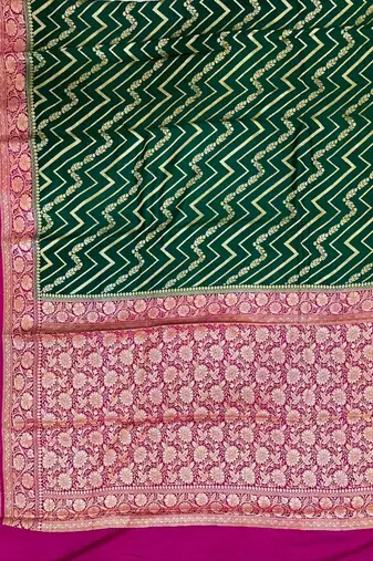 Banarasi puresilk munga saree in bottle green colour with floral zari work