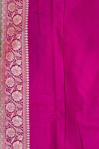 Banarasi puresilk munga saree in bottle green colour with floral zari work