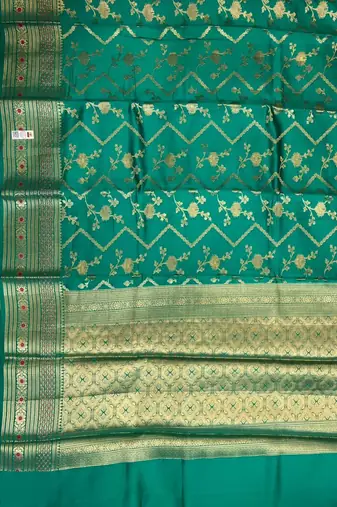Banarasi  pure silk chiniya saree in teal green colour with floral  zari zig-zag pattern with red colour meenakari
