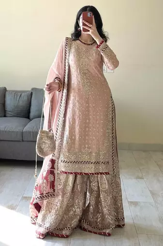 Charming light peach silk suit with intricate floral embroidery