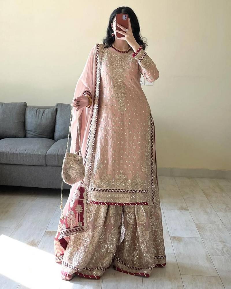 Charming light peach silk suit with intricate floral embroidery