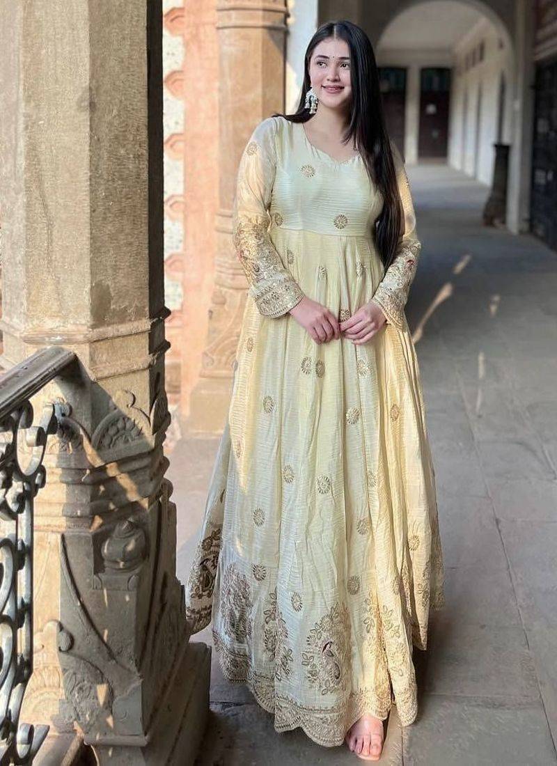Cream anarkali gown with intricate zari embroidery