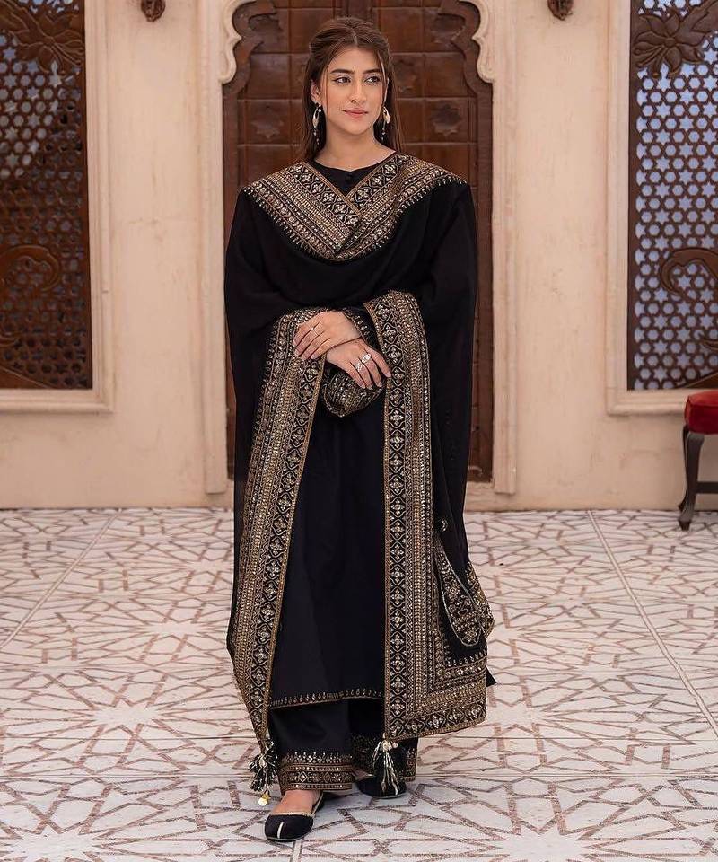 Opulent midnight black velvet suite with traditional gold tilla work