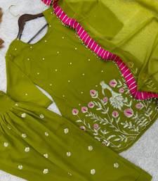 Moss green patiala salwar suit with floral threadwork and pink accents