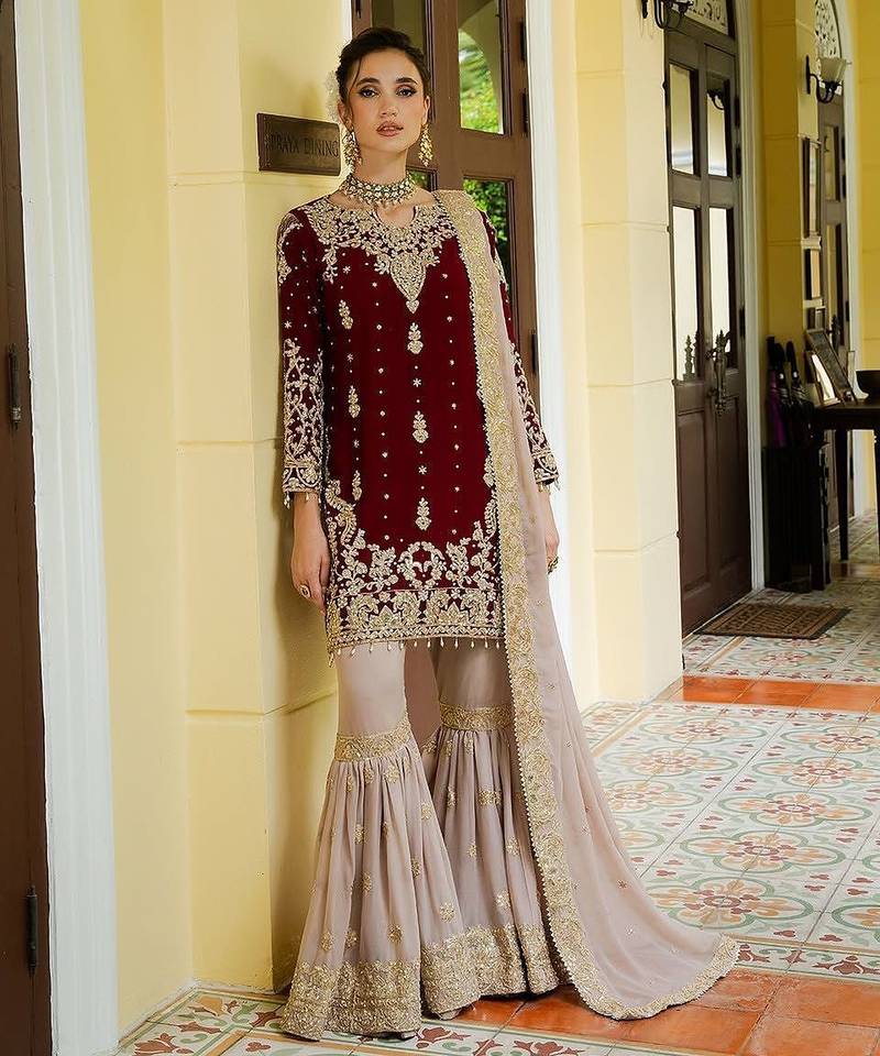 Deep maroon velvet sharara set with heavy gold tilla embroidery