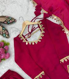 Vibrant fuchsia pink crepe salwar suit with mirror work accents