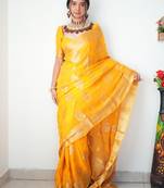 Yellow linen blend banarasi saree with unstitched blouse piece