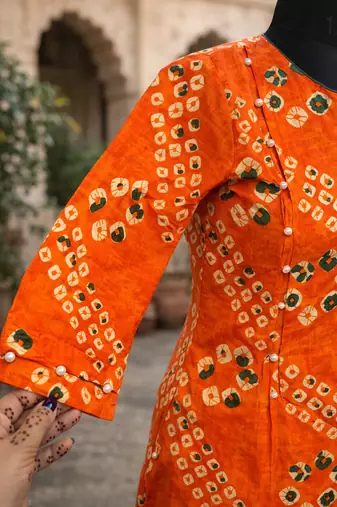 Orange bandhej kurta with pantpeal embelishment on sleeves & body