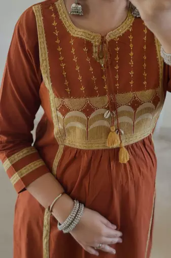 Rust kurta set with tassel accents