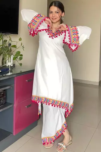 Modern white kaftan-style tunic with vibrant geometric border and pom-poms