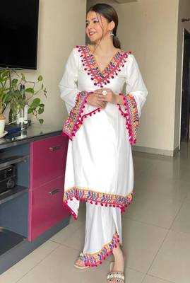 Modern white kaftan-style tunic with vibrant geometric border and pom-poms 3