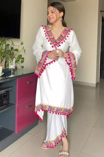 Modern white kaftan-style tunic with vibrant geometric border and pom-poms