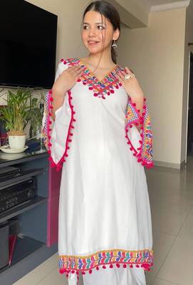 Modern white kaftan-style tunic with vibrant geometric border and pom-poms 4