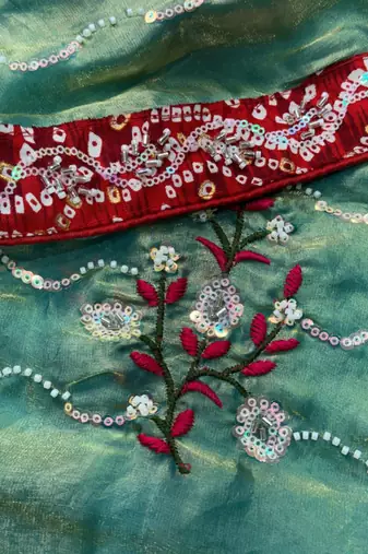Teal green saree with red blouse