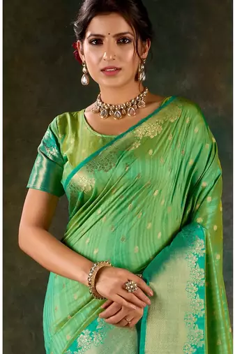 Mint green and emerald silk saree with traditional gold zari accents
