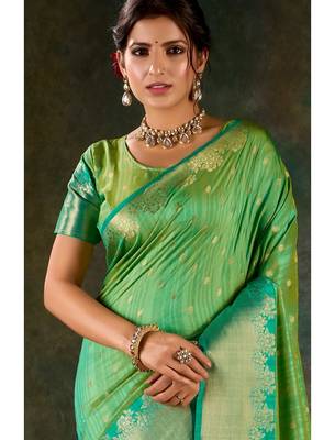 Mint green and emerald silk saree with traditional gold zari accents 2