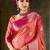 Vibrant pink and orange banarasi silk saree with traditional floral zari
