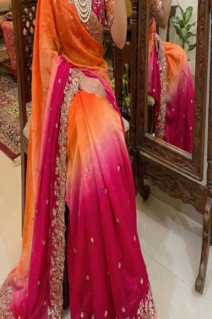 Orange Color embroidery sequence border and tussels Chinon Saree
