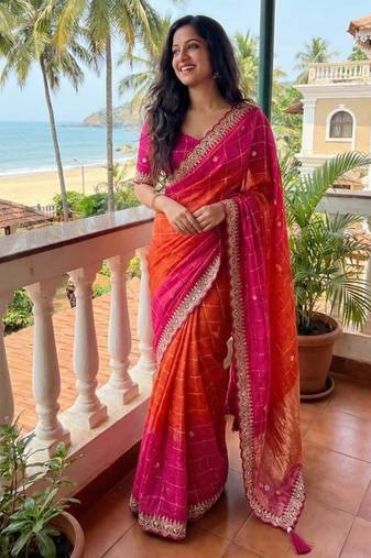 Orange Color embroidery sequence border and tussels Chinon Saree