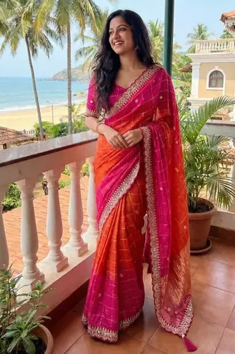 Orange Color embroidery sequence border and tussels Chinon Saree