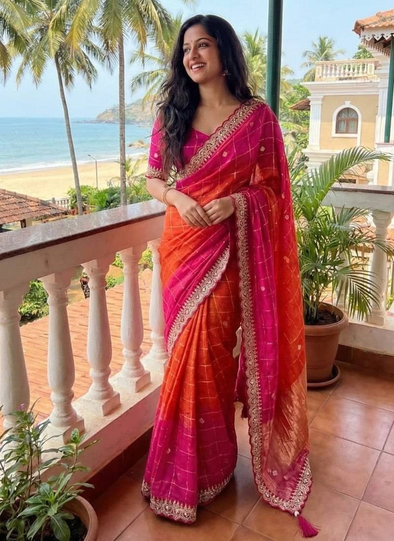 Orange Color embroidery sequence border and tussels Chinon Saree