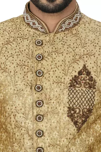Gold straight pattern work on zari jamewar fabric with hand work on collar ,hand and front indo western