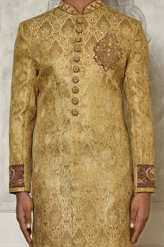 Gold straight pattern work on zari jamewar fabric with hand work on collar ,hand and front indo western