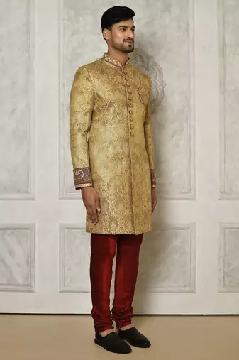 Gold straight pattern work on zari jamewar fabric with hand work on collar ,hand and front indo western