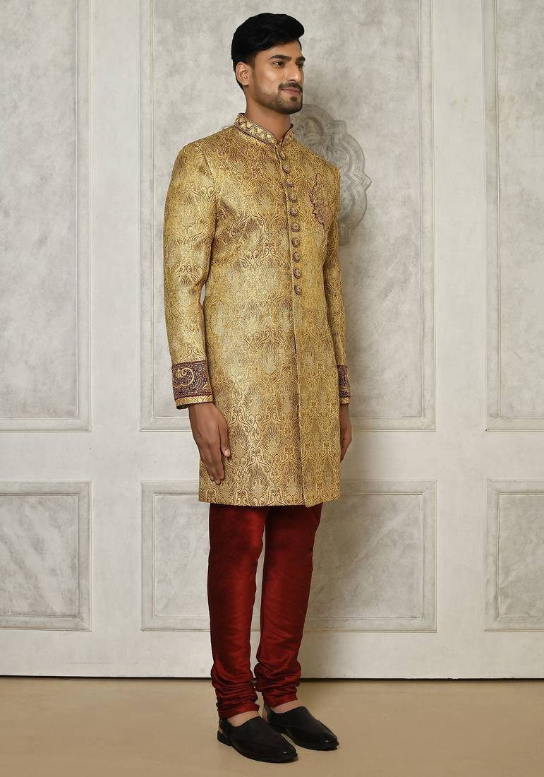 Gold straight pattern work on zari jamewar fabric with hand work on collar ,hand and front indo western