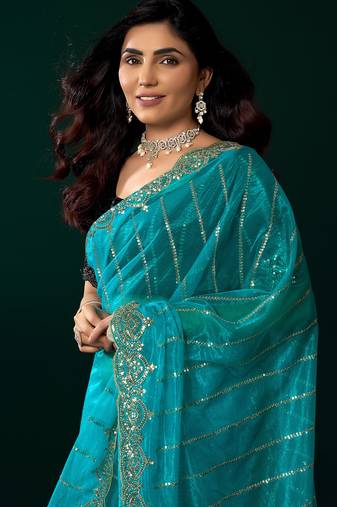 Women turquoise blue embroidered net saree