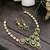 Traditional kundan & green stone necklace set with pearl accents & matching drop earrings for women