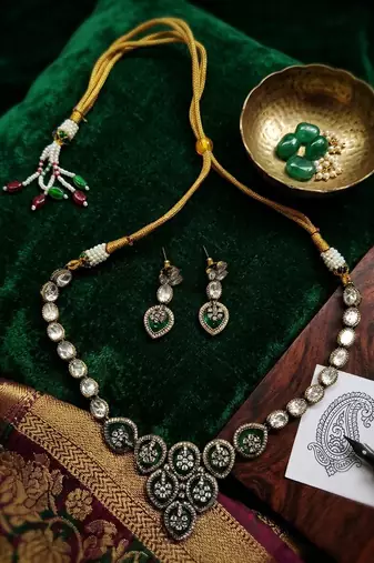 Traditional kundan & green stone necklace set with pearl accents & matching drop earrings for women