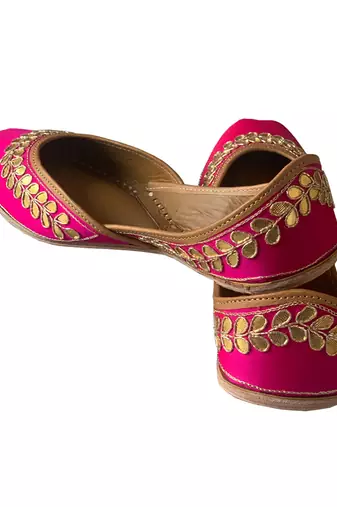 rani pink leather juttis with floral embroidered design