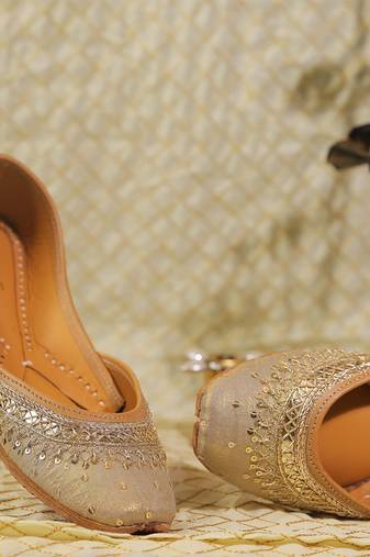 Muted gold embroidered leather juttis