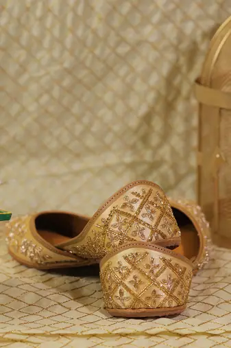 gold ethnic leather juttis with floral embroidery design