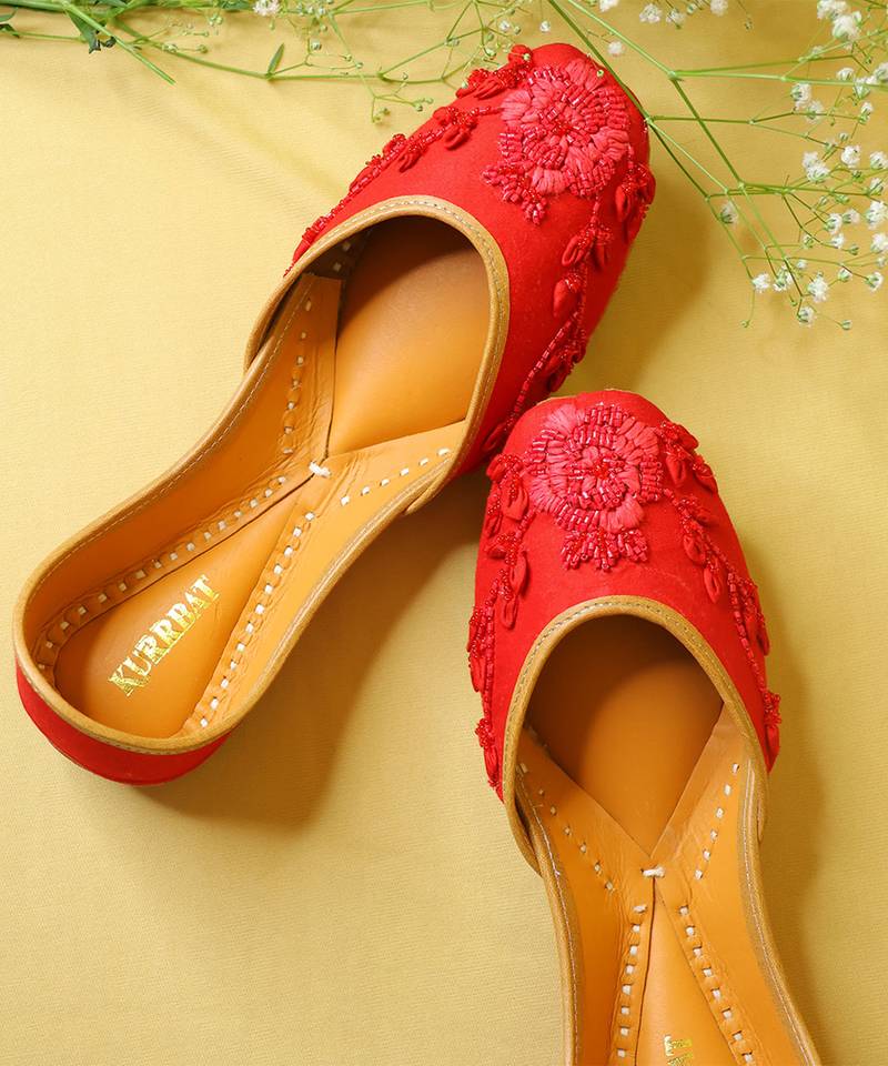 Red embroidered leather juttis
