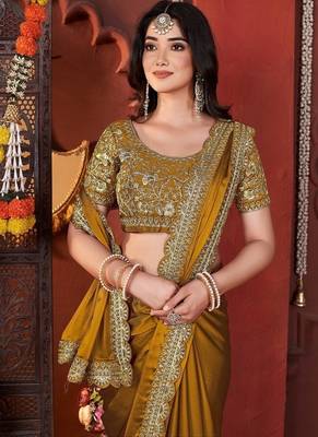 yellow heavy embroidered silk blend party wear saree 1