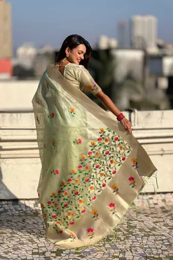 Green with multicolor accents  woven zari floral motifs work
 paithani style saree  with blouse piece